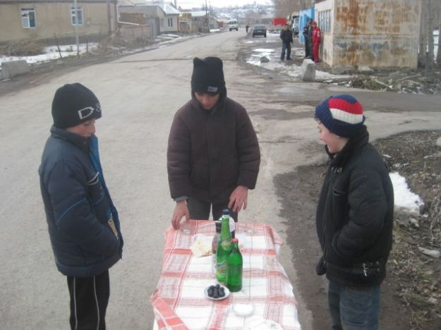 Local kids selling shots of vodka to those that pass by.